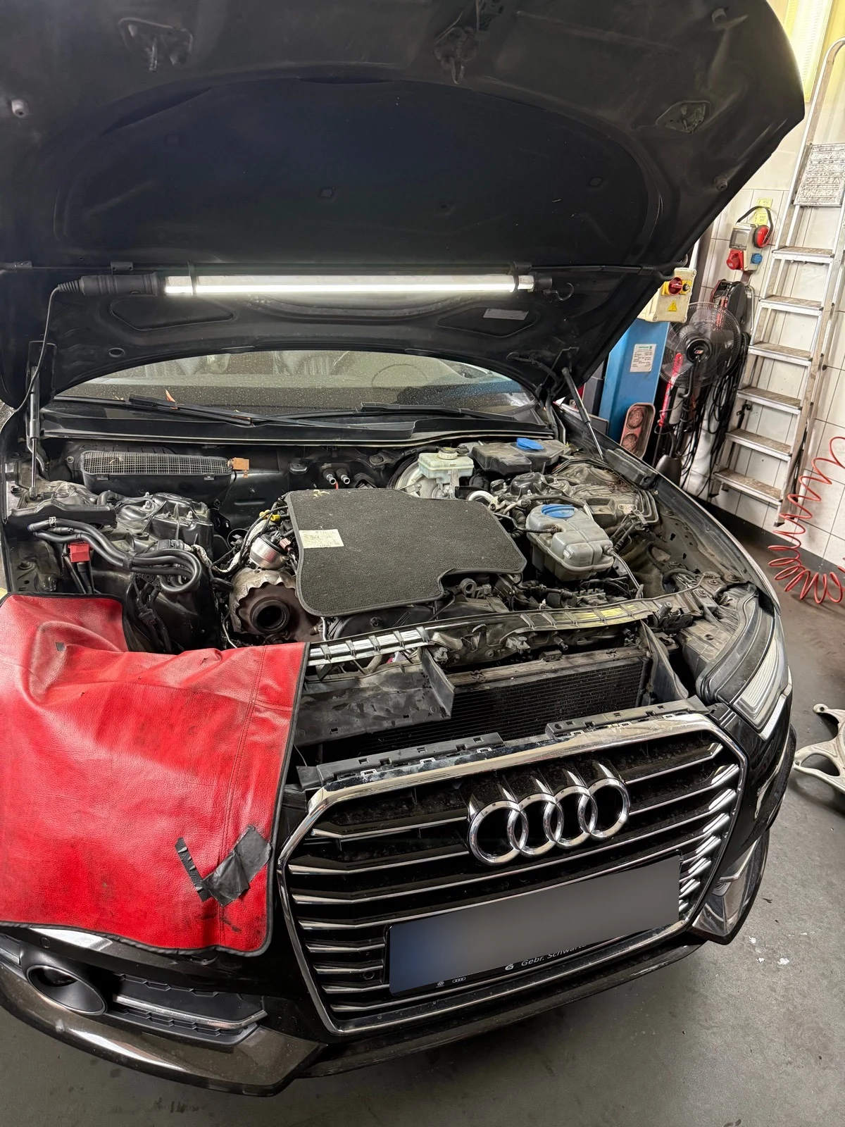 Audi megbontott motortere a műhelyben.
